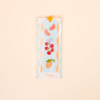 The Darling Effect’s Fruit Market Acrylic Bookmark features vibrant grapefruit, tomato, and pear illustrations—perfect for book lovers or gifting—presented in a clear sleeve on a light beige background.
