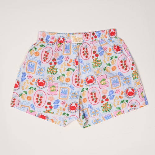 The Darling Effect’s Ciao Bella All Day Boxer Shorts feature a playful fruit, dessert, and floral print in red, blue, orange, and green on breathable fabric with an elastic waistband—perfect for kids’ comfort and style.