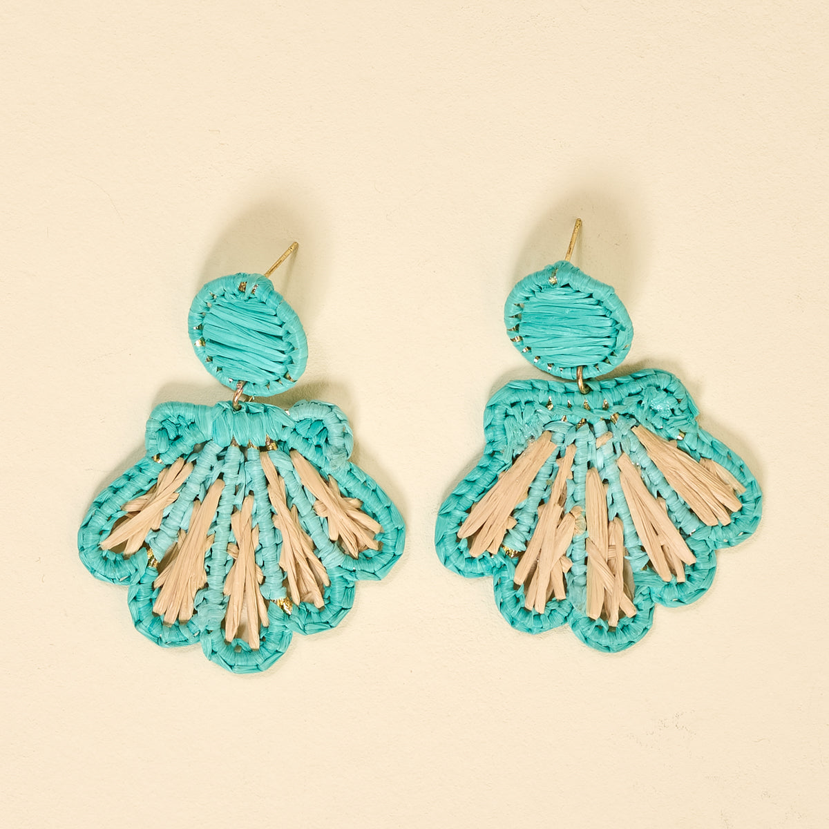The Darling Effect's Aqua Cabana Breeze Earrings feature turquoise and beige fan-shaped designs with circular tops and scalloped edges—perfect for everyday wear. Shown against a light beige background.