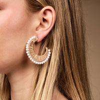 The Darling Effect's Golden Sand It-Girl Earrings feature a woven texture with white beads—lightweight hoops ideal for effortless everyday style.