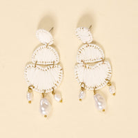 The Darling Effect’s White Pearl Affair Earrings feature three-tiered white woven semicircles, gold accents, and dangling irregular pearls—lightweight and perfect for everyday wear.