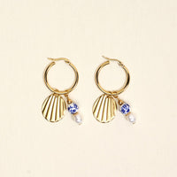The Darling Effect Shell Belle Signature Hoop Earrings feature gold hoops with fluted charms, blue and white beads, and pearl drops—perfect for elevating your everyday style.
