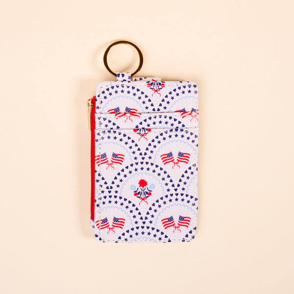 The Darling Effect's All-American Darling Keychain Wallet features a zippered pouch and keyring, decorated with American flag patterns and patriotic symbols—ideal as a slim wallet or card holder for daily use.
