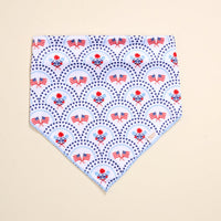 The Darling Effect's Bow-Wow Pet Bandana-All-American Darling is a white cotton accessory with blue trim, adorned with American flags, blue stars, and patriotic florals—perfect for stylish patriotic pups.