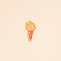 Add playful color to your style with The Darling Effect's Ice Cream Cone Mix & Match Iron-On Patch—featuring a pink scoop, orange outline, and lemon slice on top. Displayed on a beige background, it's perfect for easy customization.
