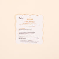 The Darling Effect’s Ice Cream Cone Mix & Match Iron-On Patch instruction card guides you to personalize items—just place, press with heat, and cool. Colorful designs and safety details are included at the bottom.