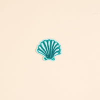 The Darling Effect’s Seashell Mix & Match Iron-On Patch features teal embroidered scallop shell details on a pale peach background—ideal for adding colorful flair to your jackets and accessories.