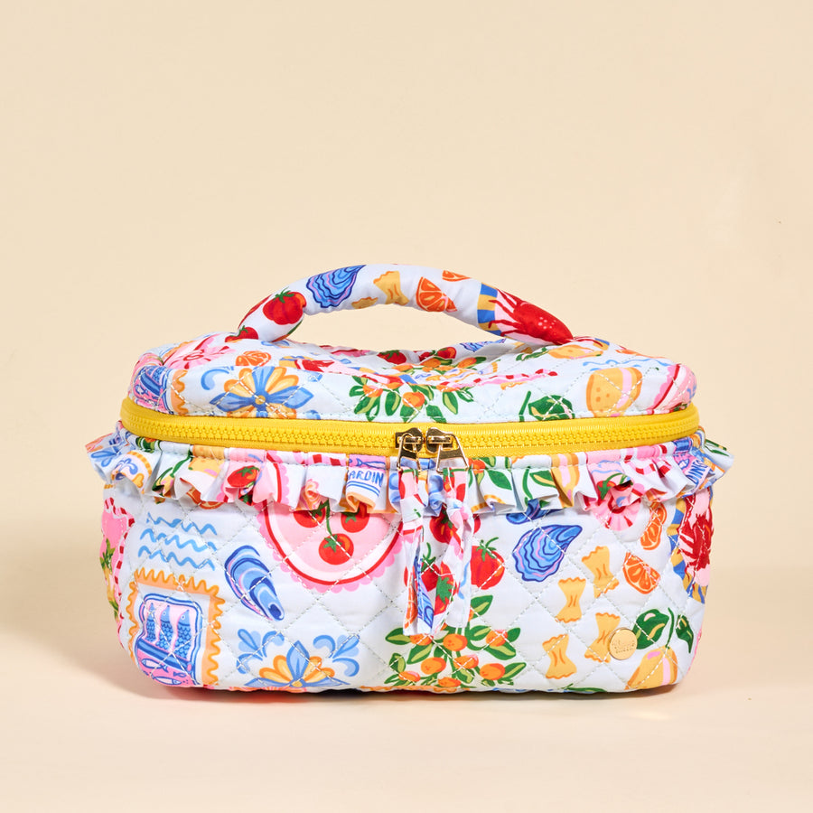 The Darling Effect's Ciao Bella Glam & Go Quilted Cosmetic Bag features a colorful Italian food print on white, a yellow zipper and handle, and is water-resistant—perfect for travel or daily use.
