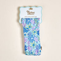 The Coastal Cove Sunglasses Case by the-darling-effect features a blue, pink, and green floral print on a puffy light cream background. Stylishly protects glasses and comes in branded packaging.