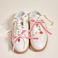 Add playful flair to your look with The Darling Effect's Berry Fresh Dazzle Shoe Charm Pack—adorable sneaker accessories featuring red gingham bows, pearl strings, and strawberry and flower charms.