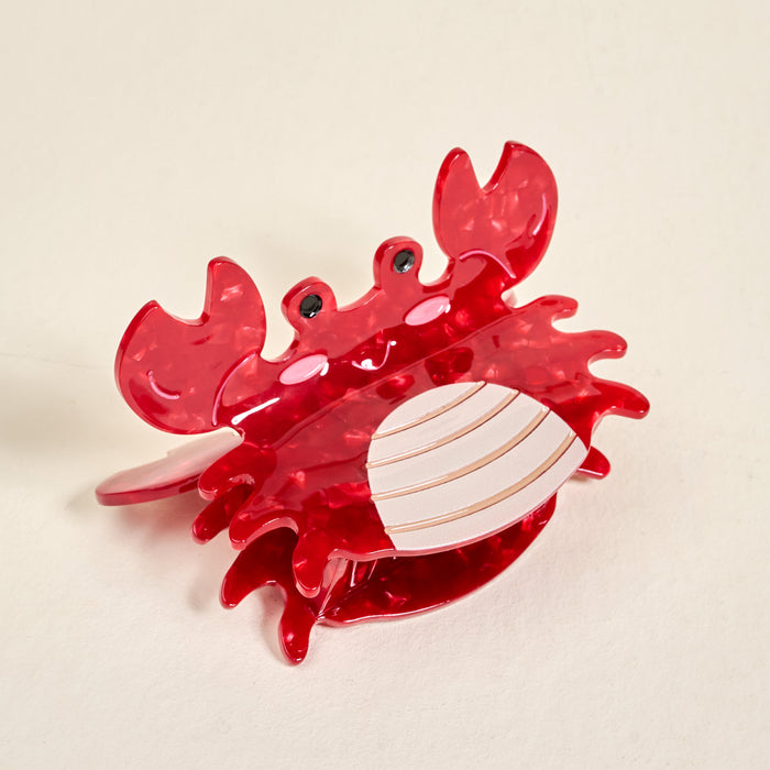 The Darling Effect’s Crab Shape Up Claw Clip is a red, crab-shaped hair accessory with googly eyes and detailed claws, featuring visible metallic teeth—perfect for adding fun to any cute hairstyle.