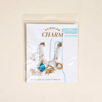 Add coastal flair to your tumbler with The Darling Effect’s Seaside Sparkle Tumbler Charm, featuring a blue gem, gold crab, and gold seashell—an eye-catching accessory for your handle.
