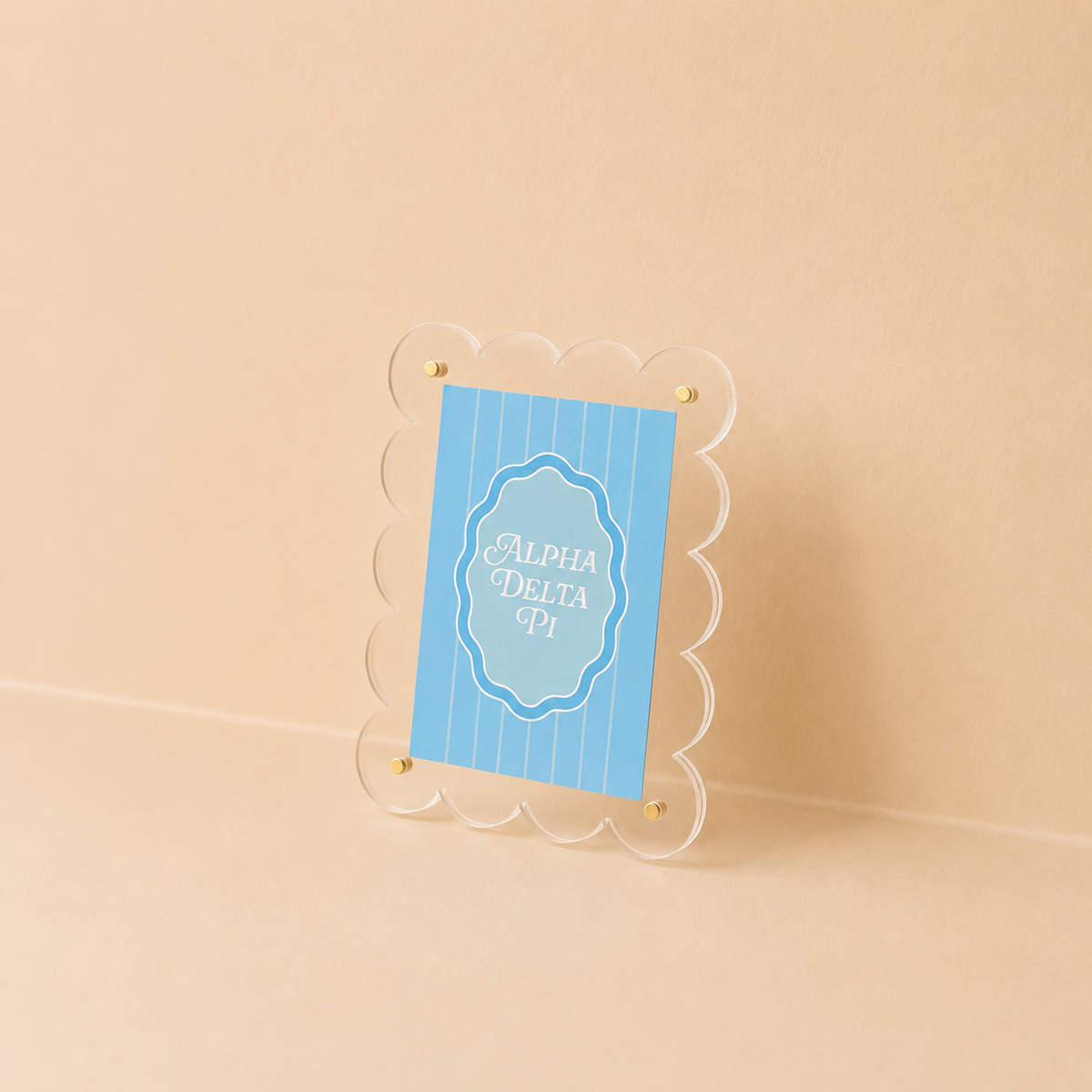 The Darling Effect's Alpha Delta Pi Mini Acrylic Picture Frame Magnet features a scalloped clear border and holds a blue card with "Alpha Delta Pi" in white script—perfect for decorating your mini fridge.