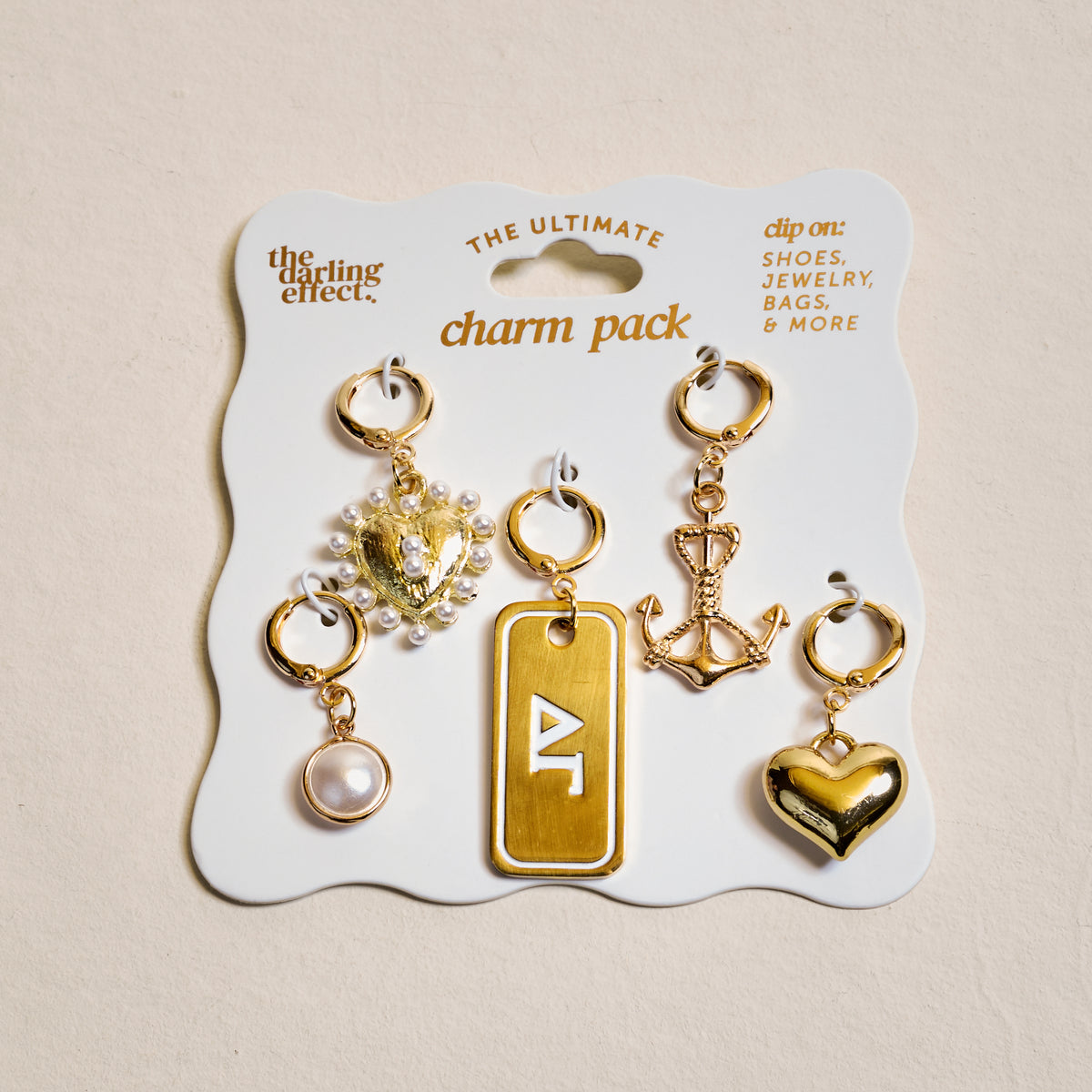 Delta Gamma The Ultimate Charm Pack by The Darling Effect includes five gold charms—a pearl, jeweled crest, gold triangle tag, scepter, and heart—perfect for Scrunchie Charm Sets and showing Sorority Spirit.