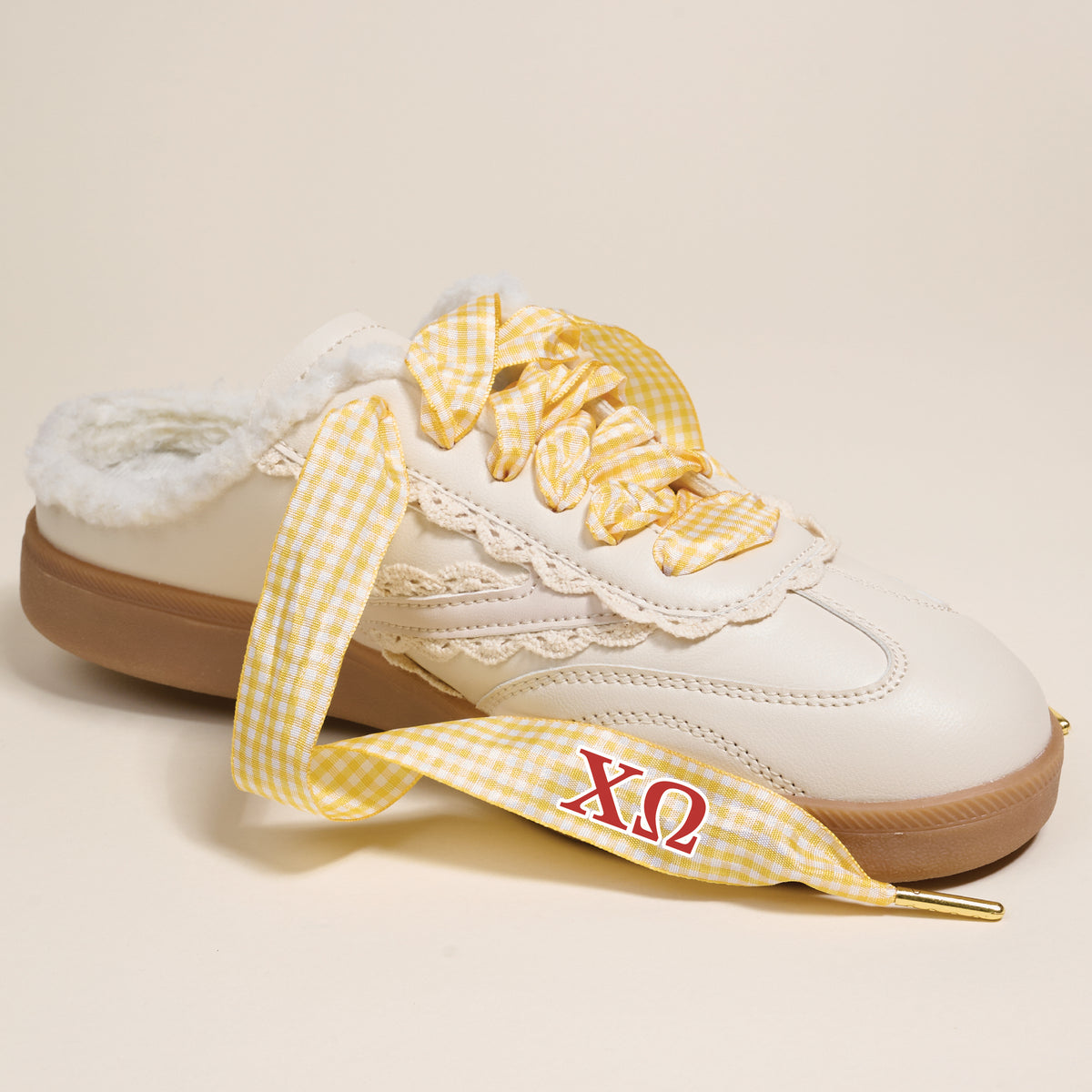 The Darling Effect’s Chi Omega Step It Up Shoelaces feature yellow gingham with red ΧΩ Greek letters, designed to upgrade any white slip-on sneaker—ideal as a sorority gift.