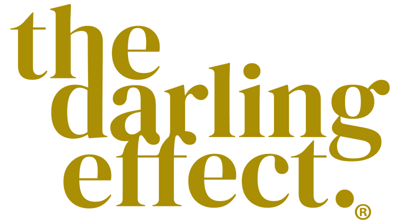 Gold text on a white background reads the darling effect. in large, overlapping serif letters, with the registered trademark symbol at the bottom right.