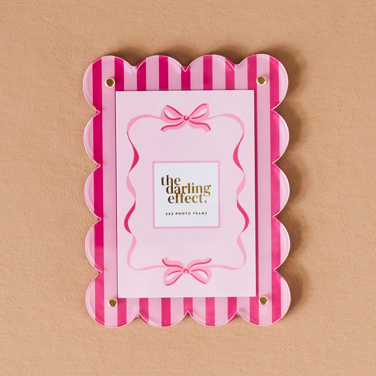 Sweetheart Stripes Mini Acrylic Picture Frame Magnet with a rectangular shape, scalloped edge, and pink vertical stripes, holding a pink card decorated with bows as a polaroid display.