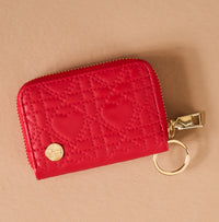 Red Hearts Zip Around Wallet by The Darling Effect in red with a quilted heart pattern, 14 card slots, and a gold zip-around closure.