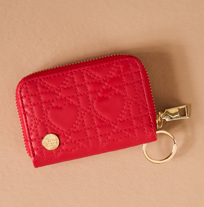Red Hearts Zip Around Wallet by The Darling Effect in red with a quilted heart pattern, 14 card slots, and a gold zip-around closure.