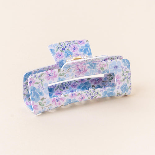 The Secret Garden Blue Claw Clip by the-darling-effect features a pastel floral print in blue, purple, and green on a light background, combining style with a strong hold for your hair.