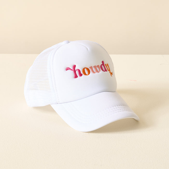 The Darling Effect's Howdy Trucker Hat features mesh sides and "howdy" embroidered in a pink, orange, and yellow gradient on the front, shown on a light-colored surface.