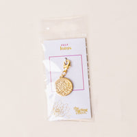 The July Jewelry Birth Flower Charm Gold by the-darling-effect comes on a card labeled JULY lotus in a clear plastic sleeve—a thoughtful gift for personalized jewelry lovers.