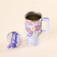 The-darling-effect’s Bouquet Beauty Purple 20 oz Lifestyle Flip Straw Tumbler with a floral design and handle sits on a light surface. Its clear, leak-resistant lid is beside it, and "Uplifting Effect" is written in gold on the mug.