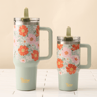 Two Bouquet Beauty Sage 20 oz Lifestyle Flip Straw Tumblers by the-darling-effect feature red, orange, and pink floral patterns, leak-resistant clear lids with green flip straws, and “The Stirling Effect” in gold at the base, on a white tiled surface.