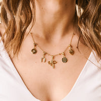 The Chloe Beaded Necklace Chain by the-darling-effect features charms like a star, horseshoe, bow, compass, and heart—a versatile gold chain that's perfect as a custom charm necklace for any occasion.