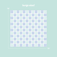 The Darling Effect Flower Check Blue On-the-Go Quilted Blanket features a 78"x78" size, checkered blue with lavender and white floral pattern, and "large size!" text above on a light green background.