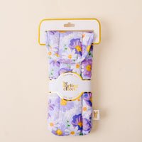 The Bouquet Beauty Purple Sunglasses Case by the-darling-effect showcases a floral quilted design with purple, yellow, and white flowers and features a convenient magnetic flap closure. It comes packaged with a white and gold label reading “the darling effect” set against a beige background.