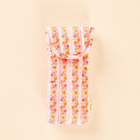 The Petal Parade Pink Sunglasses Case by the-darling-effect is shown against a pale beige background. Featuring a pink and white striped quilted design adorned with small floral details, this charming fabric pouch offers stylish protection for your glasses and includes a convenient magnetic flap closure to keep your eyewear secure.