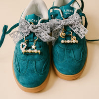 Add a touch of whimsy with the Stardust Dazzle Shoe Charm Pack by the-darling-effect—featuring pearls, stars, and hearts to decorate your laces for truly unique footwear accessories.