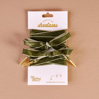 Velvet Green Step It Up Shoelaces by The Darling Effect feature durable green velvet laces with gold tips, combining style and quality—ideal for anyone seeking fashionable shoelaces.