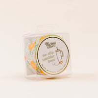The-darling-effect’s Bouquet Beauty Sage Tumbler Silicone Boot protects your tumbler from dents with its floral-patterned silicone in orange, white, and green. Packaged in a clear box labeled "the darling effect no-slip tumbler boot.