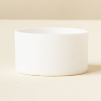 The Darling Effect White Tumbler Silicone Boot is shown on a light, cream surface with a neutral background, offering added protection for your tumbler.