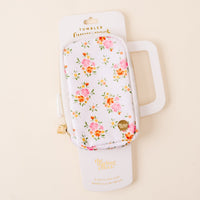 The Endless Daydream Cream Tumbler Fanny Pack by the-darling-effect is a stylish white zippered pouch with pink and yellow florals, shown on cream packaging labeled with its product and brand name.