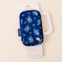 The-darling-effect's Endless Daydream Navy Tumbler Fanny Pack has a chic floral print, zipper, and gold charm. Water resistant, it's displayed on a white card reading "The Darling Effect" and "A Pouch for Your Essentials on the Go!.