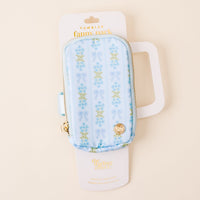 The Oh So Fancy Blue Tumbler Fanny Pack by the-darling-effect features a stylish light blue floral and bow pattern, gold zipper and charm, is water resistant, and comes on a white card with the-darling-effect logo.