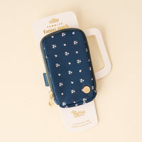 The Darling Effect's Pretty Posies Teal Tumbler Fanny Pack features a small white floral pattern, gold zipper, and water-resistant design—perfect for everyday adventures. Comes in white packaging labeled "Tumbler Fanny Pack" and "The Darling Effect.