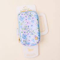 The Secret Garden Blue Tumbler Fanny Pack by the-darling-effect features a stylish blue and purple floral design, gold zippers, and water-resistant material—perfect for carrying your essentials on the go. Comes in white packaging.