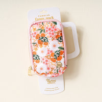 The Darling Effect's Sweet Meadow Orange Tan Tumbler Fanny Pack features a stylish, water-resistant zippered pouch with a pink, orange, and white floral pattern, perfect for everyday use.