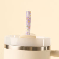 The-darling-effect’s Bouquet Beauty Purple 40 oz Tumbler Straw Set features BPA-free reusable straws with a clear design and small purple flowers with yellow centers, adding charm to any white tumbler lid or straw set.