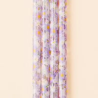Five translucent, BPA-free Bouquet Beauty Purple 40 oz Tumbler Straws by the-darling-effect, featuring purple and white flowers with yellow centers, are arranged vertically against a beige background.