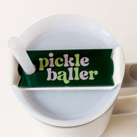 The Darling Effect's Pickleballer Tumbler Lid Tag is a green, wavy-lettered topper reading "pickle baller," perfect for personalizing your Stanley Quencher 2.0 lid or using as a unique tumbler tag.