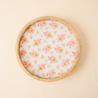 The-darling-effect’s Endless Daydream Cream Large Round Wood Enamel Tray features a pink and orange floral pattern on a white base, creating a stylish, food-safe serving tray, set against a light beige background.