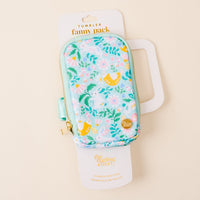 The Darling Effect's Hoppy Days Tumbler Fanny Pack is a small, zippered, water-resistant pouch with a pastel floral and bird design, perfect for carrying essentials on the go. Comes in white packaging labeled “Tumbler Fanny Pack.”.