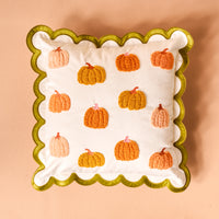 Pumpkin Patch Scalloped Square Throw Pillow with a green scalloped edge and a pattern of embroidered orange and peach pumpkins.