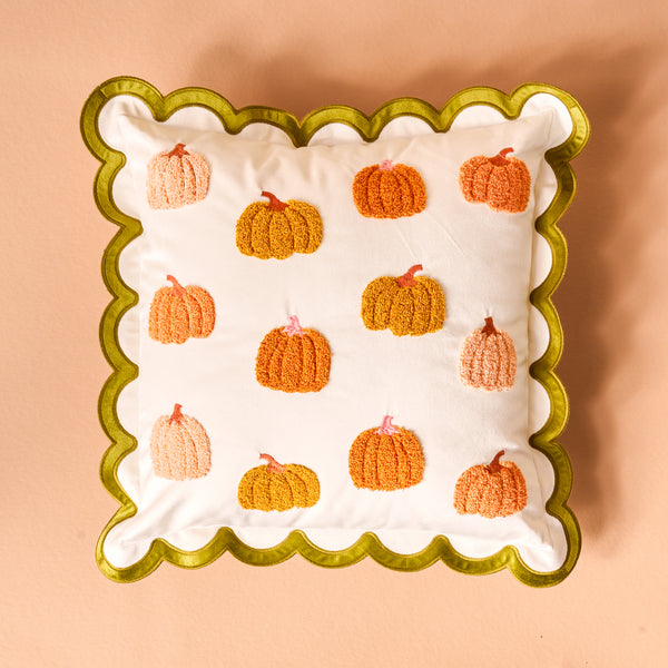 Pumpkin Patch Scalloped Square Throw Pillow with a green scalloped edge and a pattern of embroidered orange and peach pumpkins.