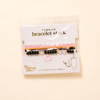 The Darling Effect’s Spook & Sparkle Tumbler Bracelet Stack includes pink, black, and pearl-like beaded bracelets with a pink ghost charm—fun 40 oz tumbler accessories on a branded “bracelet stack” and “accessorize your tumbler” card.